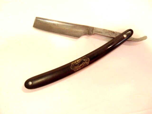 older, pre-owned straight razor marked with 