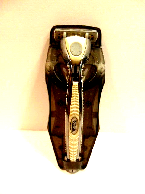 pre-owned gray Schick safety razor in plastic cradle