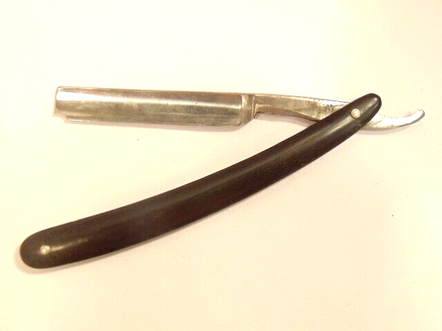 vintage straight razor with small chip on blade and the name partly obscured